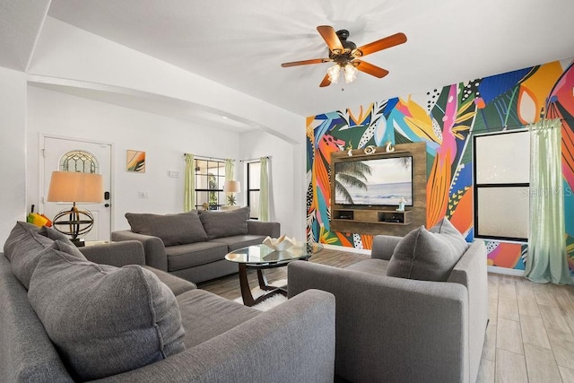 living room featuring ceiling fan and light hardwood / wood-style floors