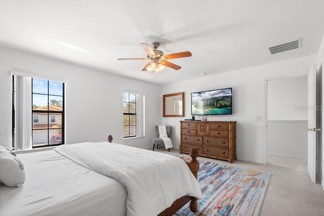 bedroom with light carpet and ceiling fan