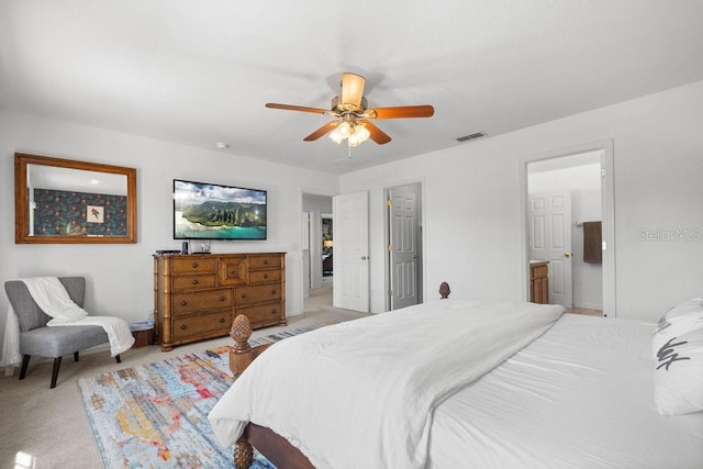 carpeted bedroom with ceiling fan and connected bathroom