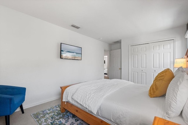 bedroom featuring light colored carpet and a closet