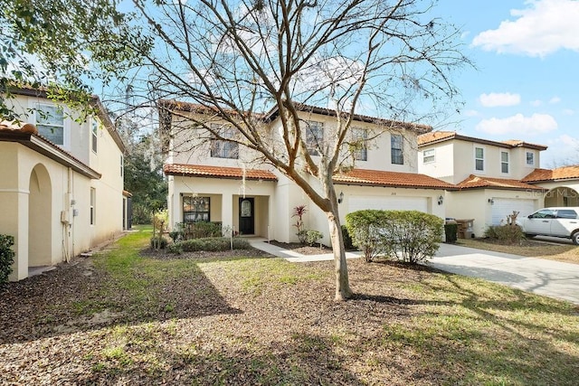 mediterranean / spanish house with a garage and a front yard