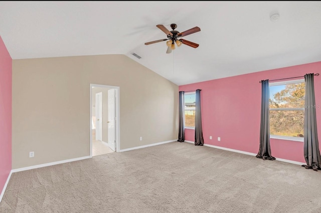 carpeted empty room featuring ceiling fan and vaulted ceiling