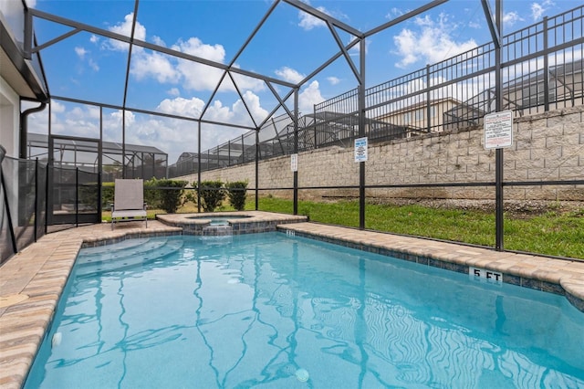 view of swimming pool with an in ground hot tub and glass enclosure