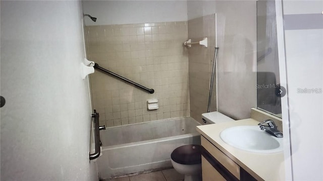 full bathroom featuring tiled shower / bath combo, vanity, tile patterned floors, and toilet