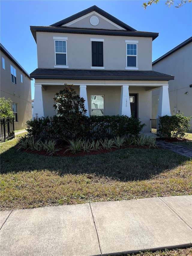 front facade with a porch and a front lawn