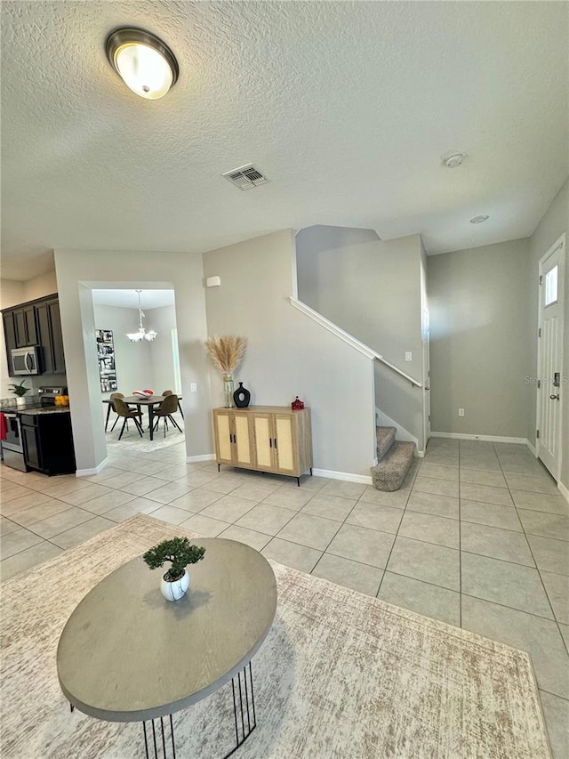 interior space with light tile patterned floors and an inviting chandelier