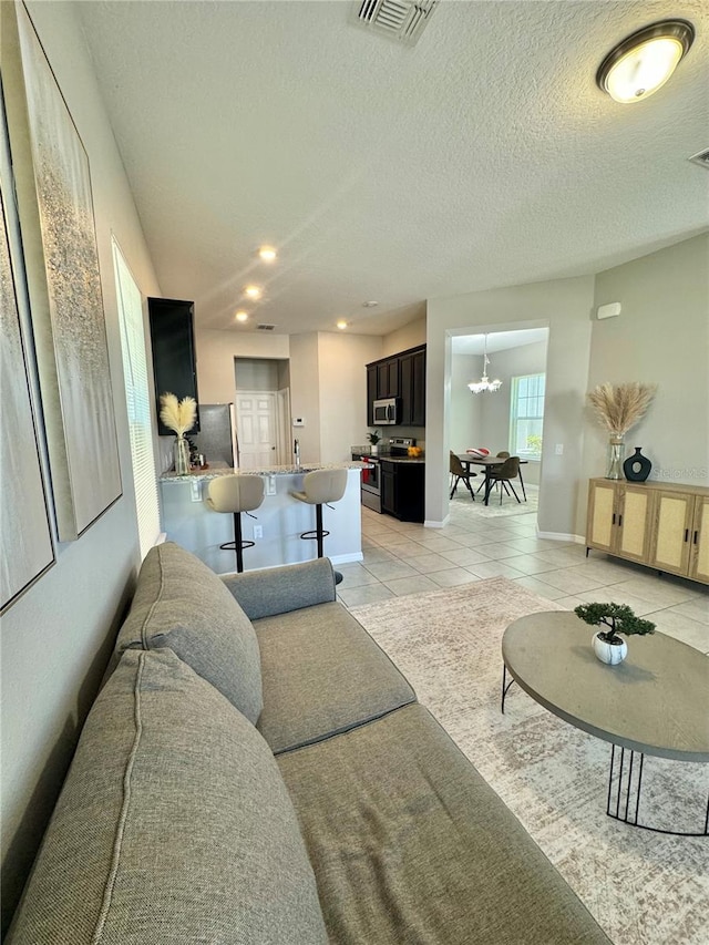 tiled living room with a textured ceiling