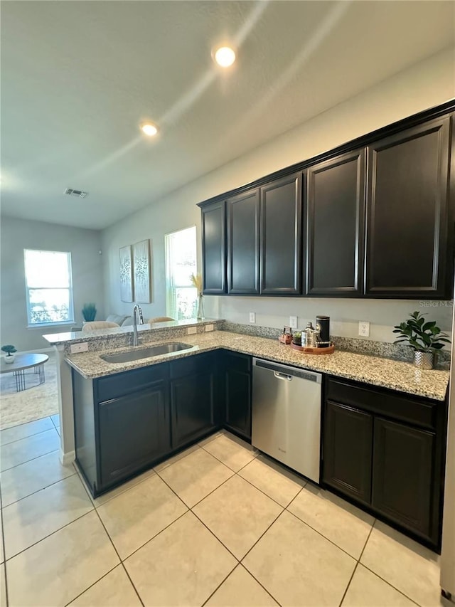 kitchen featuring dishwasher, plenty of natural light, sink, and light tile patterned floors