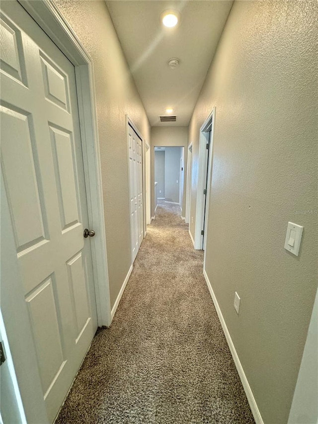 corridor with light colored carpet