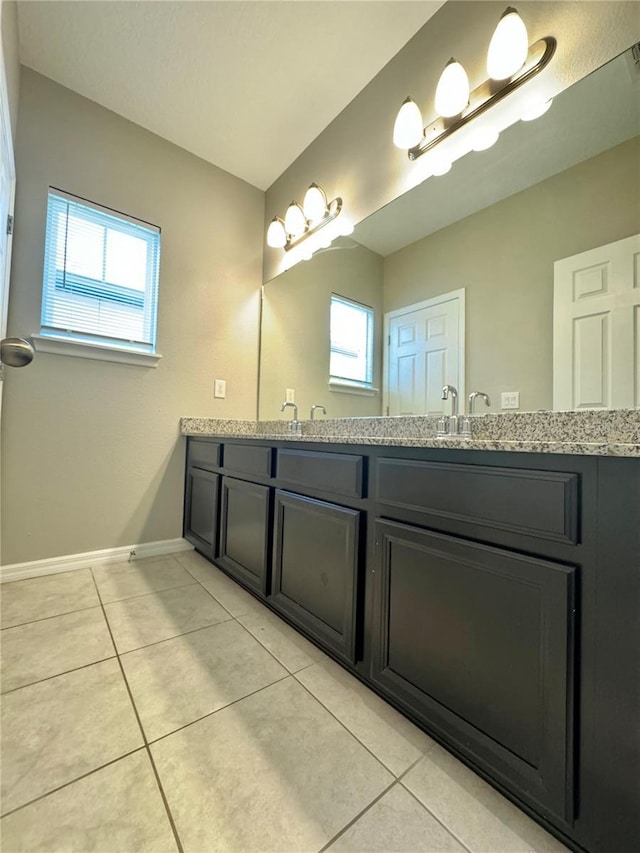 bathroom with tile patterned floors, vanity, and a wealth of natural light