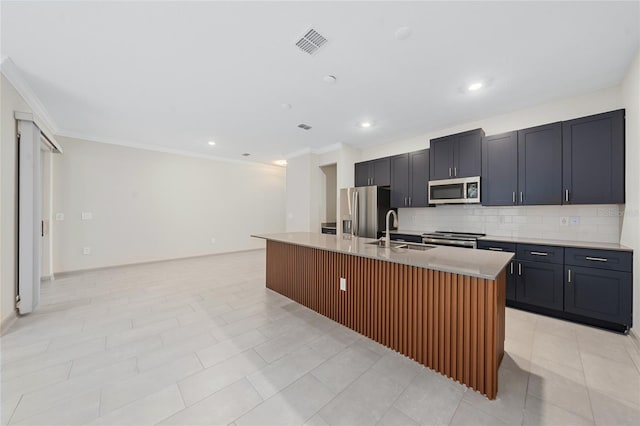 kitchen featuring sink, crown molding, a kitchen island with sink, backsplash, and stainless steel appliances