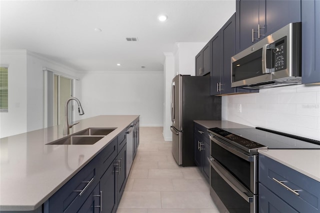 kitchen with blue cabinets, sink, light tile patterned floors, ornamental molding, and stainless steel appliances