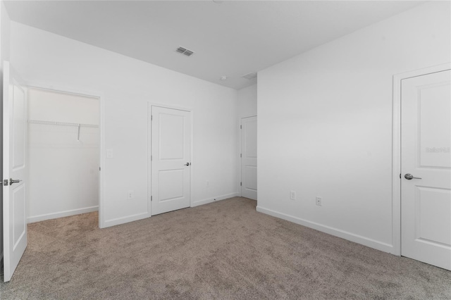 unfurnished bedroom featuring light colored carpet