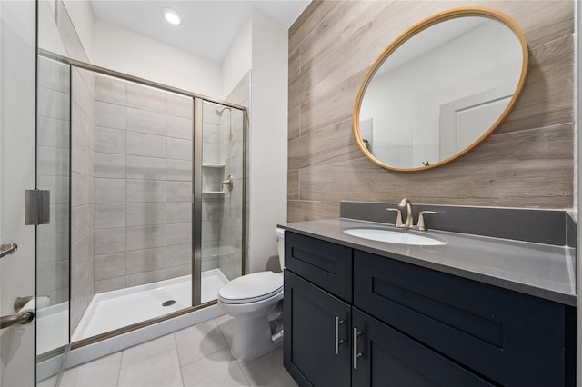 bathroom featuring vanity, toilet, an enclosed shower, and tile patterned flooring