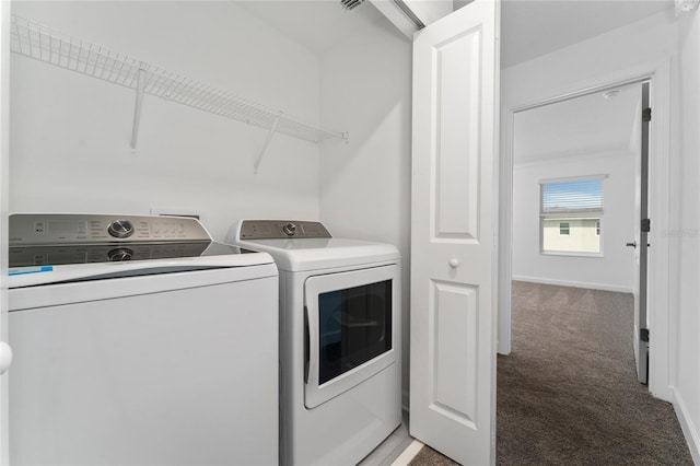 washroom featuring separate washer and dryer and carpet floors