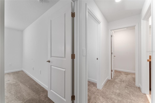 hallway with light colored carpet