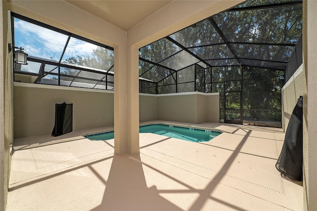 view of pool featuring a patio area and glass enclosure