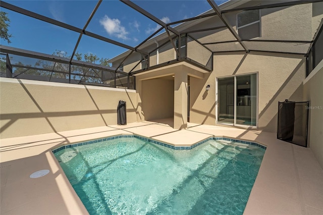 view of swimming pool featuring a lanai and a patio area