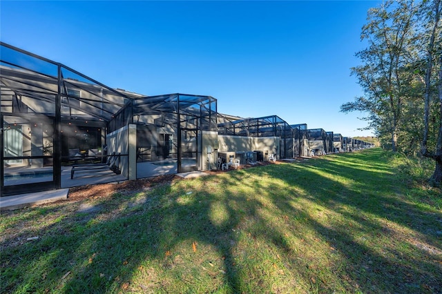 view of yard with glass enclosure