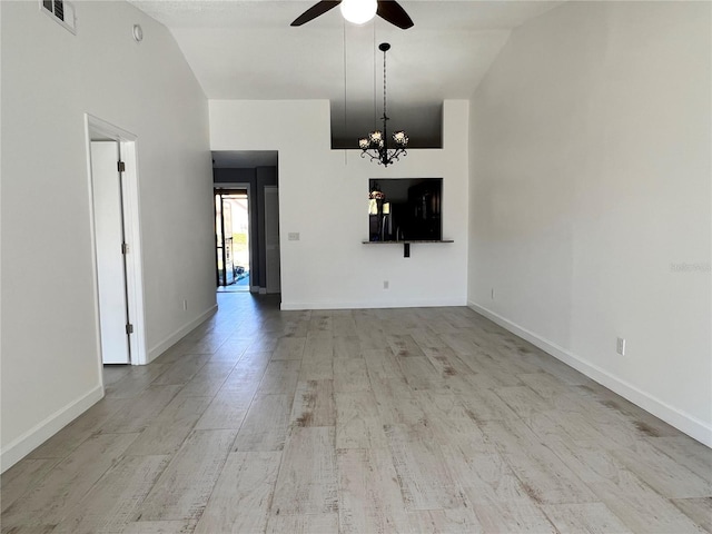 interior space with ceiling fan with notable chandelier, high vaulted ceiling, and light wood-type flooring