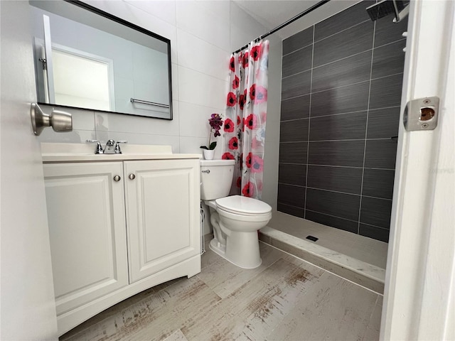 bathroom featuring vanity, toilet, tile walls, and a shower with curtain