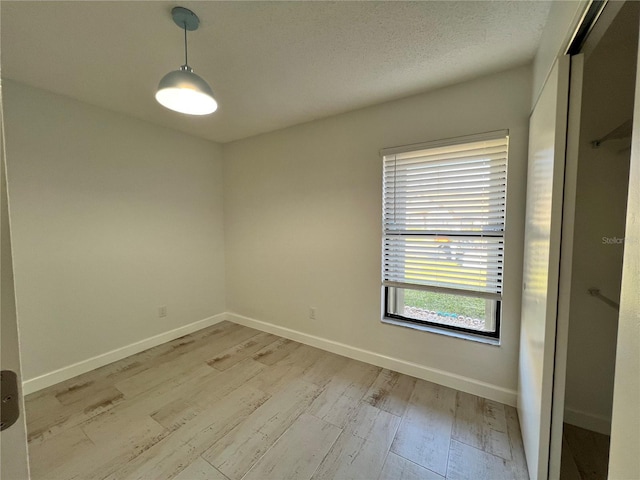 spare room featuring light wood-type flooring