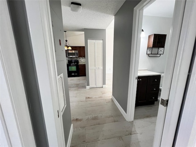 corridor featuring a textured ceiling