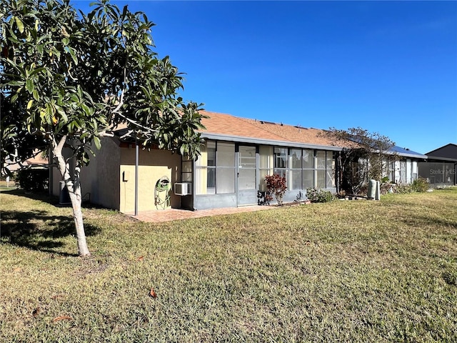 rear view of property featuring cooling unit and a yard