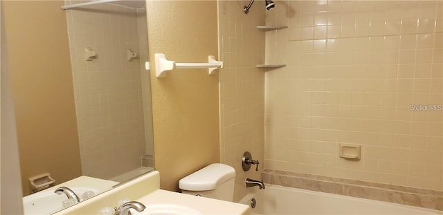 bathroom with toilet and tiled shower / bath combo