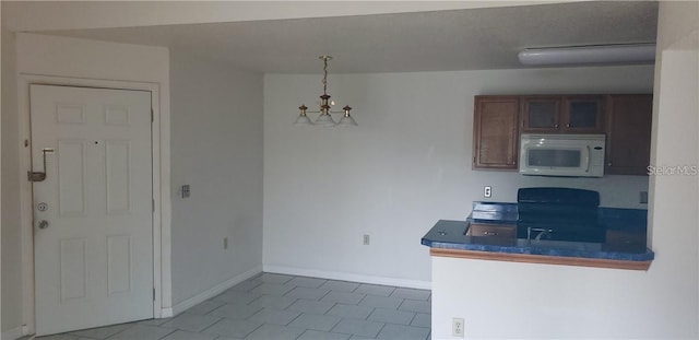 kitchen featuring stove and decorative light fixtures