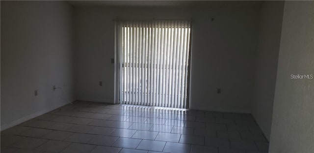 spare room with tile patterned floors