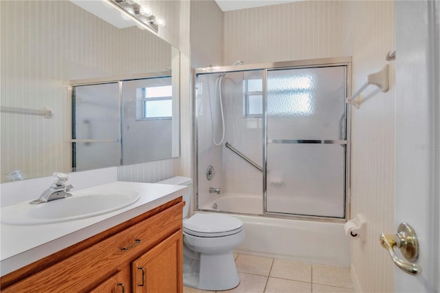 full bathroom featuring vanity, tile patterned floors, enclosed tub / shower combo, and toilet