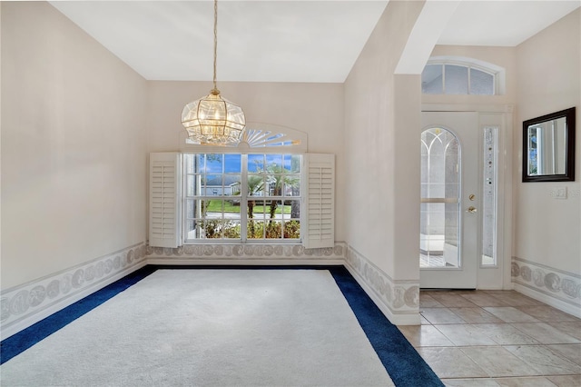 foyer featuring an inviting chandelier and a wealth of natural light