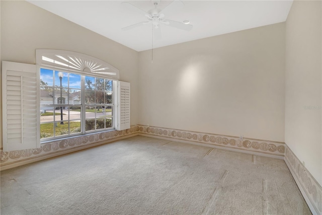 spare room featuring carpet and ceiling fan