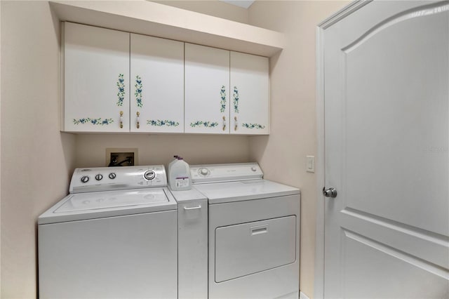 laundry area with cabinets and washing machine and clothes dryer