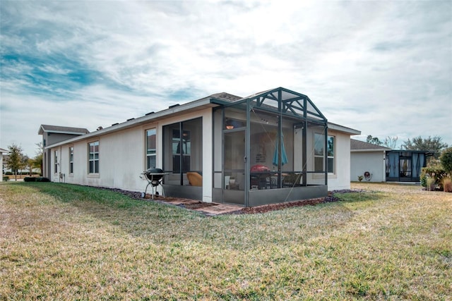 rear view of house featuring a lawn