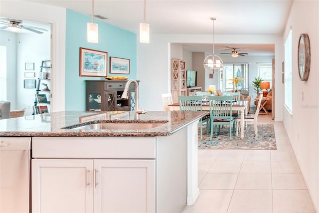 kitchen featuring hanging light fixtures, dishwasher, sink, and white cabinets