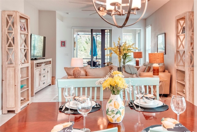 tiled dining room featuring a notable chandelier