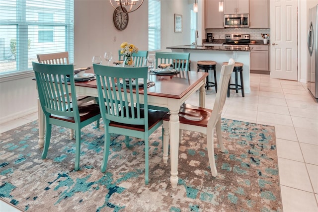 dining room featuring sink and light tile patterned floors