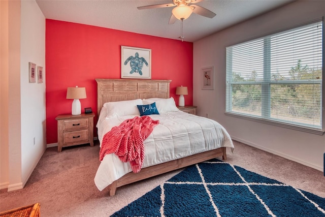 bedroom with ceiling fan, a textured ceiling, and carpet flooring