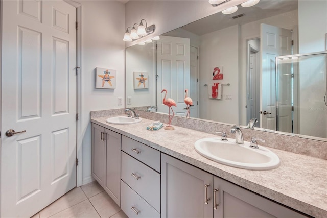 bathroom with tile patterned floors, vanity, and a shower with shower door