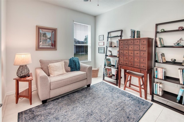 living area featuring ceiling fan and light tile patterned flooring