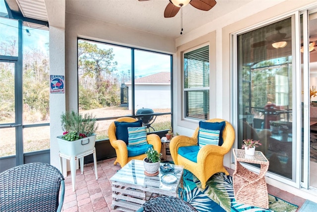 sunroom featuring ceiling fan