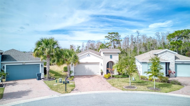 view of front of house featuring a garage and a front lawn