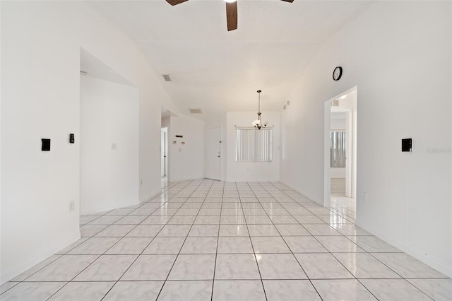 tiled spare room with ceiling fan with notable chandelier and vaulted ceiling