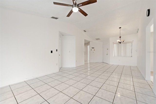 unfurnished living room with vaulted ceiling, ceiling fan with notable chandelier, and light tile patterned floors