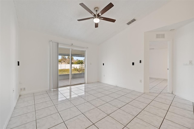 spare room featuring light tile patterned flooring, lofted ceiling, a textured ceiling, and ceiling fan