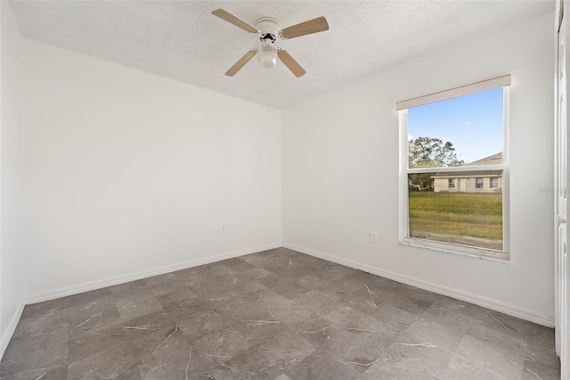 spare room featuring ceiling fan and a textured ceiling