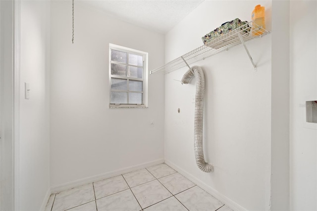 walk in closet with light tile patterned flooring