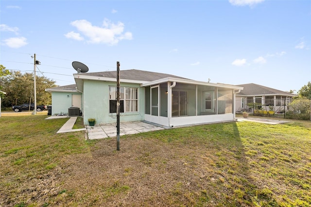 back of house featuring cooling unit, a yard, a patio area, and a sunroom